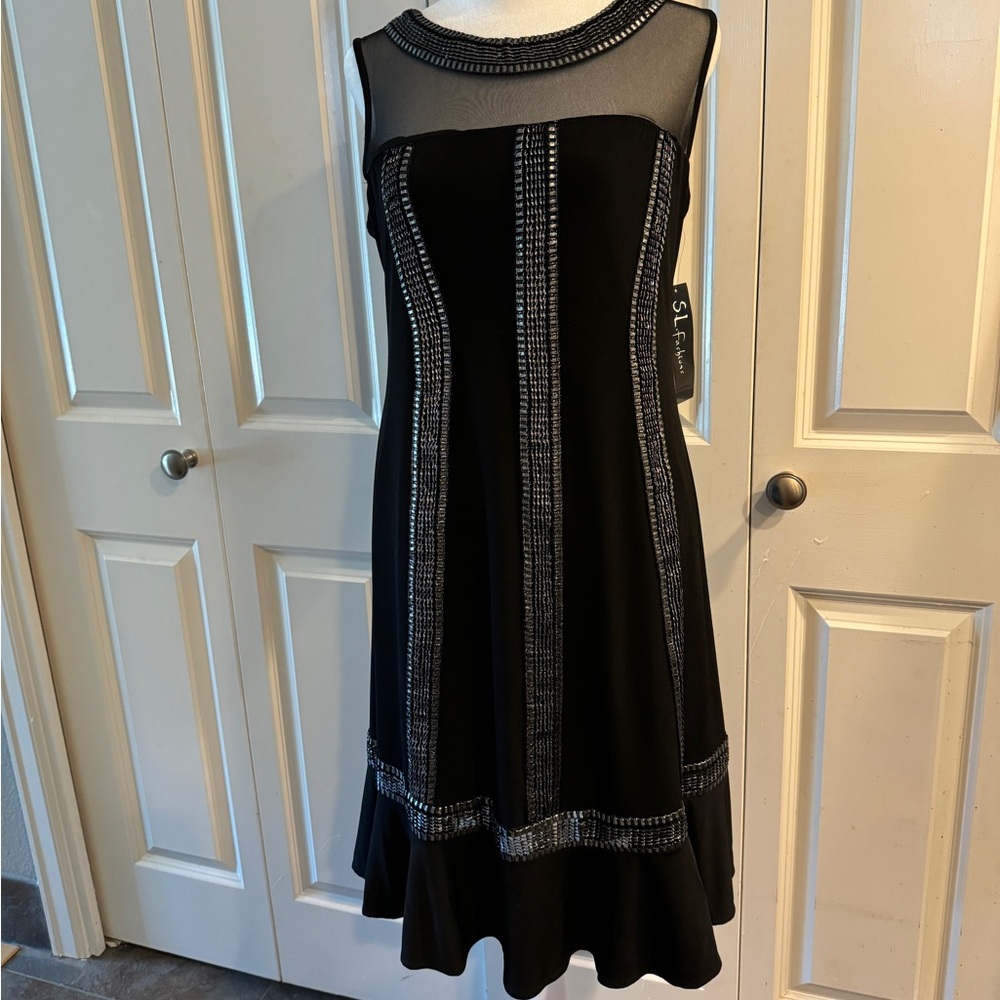 NWT…..Beautiful black dress with mesh detail. Size 10.